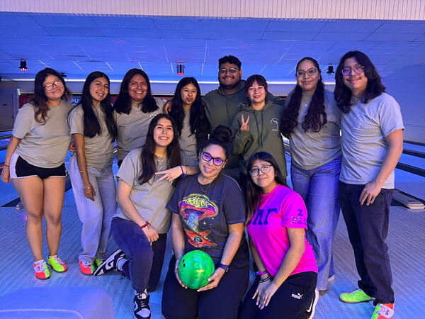 Student group poses for a photo at the bowling alley.