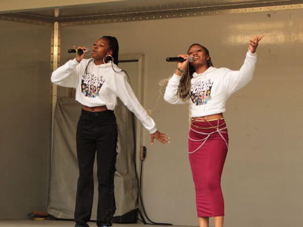 Two students perform on stage.